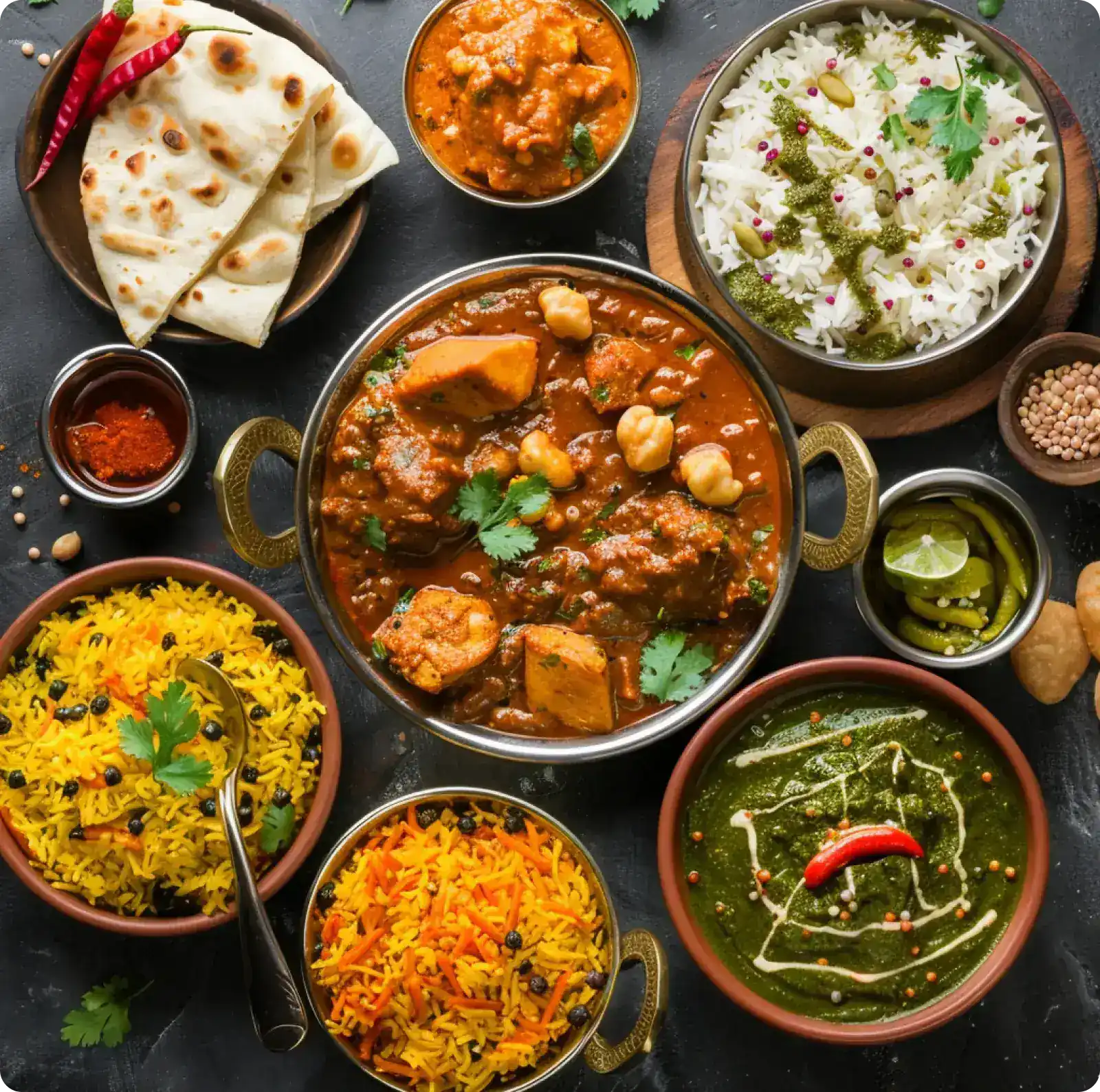 Assorted Indian dishes curries, rice, naan and sides